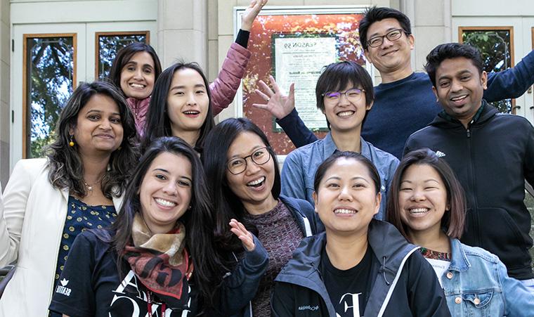 国际学生 pose on the steps of McKinley Hall during orientation